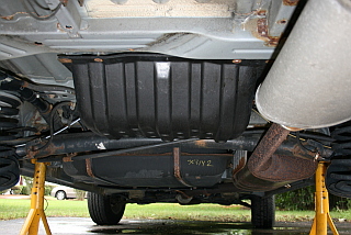 evaporative charcoal canister on a 2001 Toyota Sienna is located behind the gas tank under the car